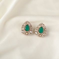 Description : This pair of silver earrings is enlivened by the floral touches, featuring moissanite stones, emerald green stones, and gold-plated silver. This timeless stud brings elegance to your festive event. Product Information : Materials used: 925 Silver with Victorian Plating Stones: Semi-precious stones Length: 3cm Findings: Push back Green Hand Set Diamond Earrings, Green Hand-set Diamond Earrings, Green Diamond Earrings For Formal Occasions, Green Diamond Drop Earrings For Bridal, Green Diamond Drop Bridal Earrings, Emerald Drop Diamond Earrings For Wedding, Green Hand Set Diamond Drop Earrings, Green Hand Set Drop Diamond Earrings, Green Hand-set Diamond Drop Earrings