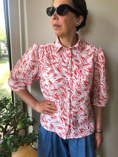 Vintage 80s white and red abstract print short sleeve blouse. Puff sleeve front buttoned blouse. Collared blouse. Summer women's outfit. Cotton colourful blouse. Marked as size 40. 100% cotton. From shoulder to shoulder 15,5" 39cm Bust 40" 102cm Sleeve length 15" 38cm Length 24" 61cm. Summer Slim Fit Buttoned Tops, Summer Slim Fit Tops With Button Closure, Slim Fit Tops With Button Closure For Summer, Summer Slim Fit Button-up Tops, Slim Fit Button-up Tops For Summer, Red Non-stretch Summer Blouse, Fall Printed Short Sleeve Blouse, Non-stretch Red Summer Blouse, Fall Season Printed Short Sleeve Blouse