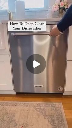 a person is opening the dishwasher door to check out what's inside