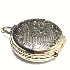 *Description: This is an unsigned Coro locket with a patent by Edwin S. Donle from the 1950s. The locket has four panels which include the front and back. The clasp is under the bail and when opened the two inner sections fit together like a clam shell. Each side could hold a photo and it is possible that two additional photos could be added. The design allows for many possibilities. I tested the surface for 10K gold and it tested as gold filled or gold plated. It is only marked with the patent Unique Locket, Formal Earrings, Vintage Christmas Gifts, Book Pieces, Curling Ribbon, Clam Shell, The 1950s, 1950s Vintage, Gold Style