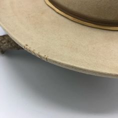 Western 50x in Sahara with custom distressing Teardrop crown Kettle curl on 3" brim Layered Elk leather accent bands Whipstitch on crown and brim Hand stitched Tonal Mountain detail Custom hand stitched initials upon request. This felt hat is made to order, please allow 6-8 weeks for delivery. Vintage Distressed Hats For Rodeo, Vintage Beige Fedora With Curved Brim, Vintage Beige Fedora With Flat Brim, Vintage Distressed Hat For Western-themed Events, Classic Hat With Curved Brim In Distressed Brown, Vintage High Crown Brown Fedora, Classic Distressed Brown Hat With Curved Brim, Vintage Beige Festival Hat, Vintage Beige Hat Bands For Rodeo