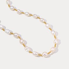 Experience the epitome of elegance with our Golden Baroque Pearl Necklace. This exquisite necklace features uniquely shaped baroque pearls, each one distinct with its own irregular and organic form, creating a one-of-a-kind masterpiece. The pearls are interspersed with delicate golden beads, adding a touch of opulence and sophistication to the design. This necklace is more than just an accessory; it is a statement of elegance and timeless beauty. DETAILS Plating: 18K Gold Materials: 18K Gold on Elegant Beaded Baroque Pearl Necklace, Gold Pearl Necklace With Baroque Pearls, Baroque Pearl Chain Necklace In Pearl White, Baroque Pearl Beaded Necklace With Round Beads, Baroque Pearl Necklace In Pearl White, Elegant Baroque Pearl Beaded Necklaces With Round Beads, Pearl White Baroque Pearl Necklace With Pearl Chain, Baroque Pearl White Necklaces, Elegant Baroque Pearl Beaded Necklaces