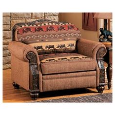 a living room with a brown chair and rug on the floor next to a brick wall