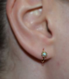 ⋙ 14kt Gold Filled opal tragus ring.⋙ This listing is for one earring.⋙ Available gauges for the ring: 20g; 18g; 16g.⋙ Please note: the less gauge number, the thicker ring is.⋙ Available interior (inner) diameters: 7mm; 8mm; 9mm; 10mm⋙ Available gemstones: ruby; lapis lazuli; black onyx; emerald; light blue opal; garnet; white opal; kiwi green opal; amethyst; aqua blue cz; clear cz; black-red opal; turquoise; blue sapphire⋙ Measurements:⋙ The stone is 2mm in diameter⋙ ⋙ I will put your order int Tiny 14k Gold Huggie Earrings, 14k Gold Birthstone Huggie Earrings As Gift, 14k Gold Huggie Earrings With Birthstone For Anniversary, Tiny Delicate Hoop Jewelry, 14k Gold Small Hoop Earrings, Delicate Tiny Hoop Jewelry, 14k Gold Pierced Small Hoop Cartilage Earrings, Dainty Tiny Hoop Earrings, Dainty Tiny Hoop Jewelry