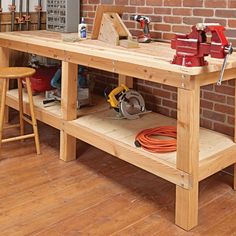 a workbench with tools on it in front of a brick wall