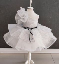 Elevate your little one's special occasion with our One Shoulder White Tutu Dress! This enchanting dress is perfect for birthdays, parties, or any celebration where your child deserves to shine. Designed with elegance and flair, it features a chic one-shoulder design and a stunning white tutu adorned with glitter. Features: Elegant One Shoulder Design: Adds a touch of sophistication and unique style. White Glittery Tutu: Sparkles beautifully, making your toddler the star of any event. Comfortabl Elegant Ruffled Baptism Dress For Party, White Fitted Princess Dress For Dress-up, Fitted White Dress For Birthday, White Fitted Dress For Birthday, White Ruffled Dresses For Party Season, Fitted Princess Style Baptism Dress For Party, Party Pageant Dress With Ruffles, White Princess Dress For Party, White Princess Style Party Dress