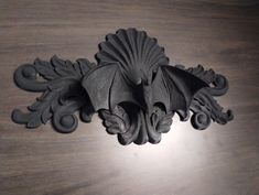 an intricately carved piece of wood on a table