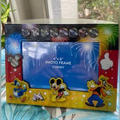 a mickey mouse photo frame sitting on top of a table