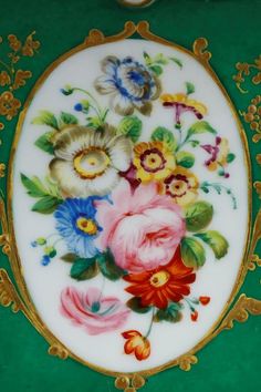 an ornately decorated plate with flowers on it