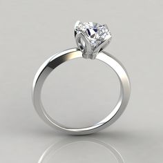 a white gold engagement ring with a single diamond