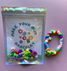 there is a plastic bag with beads and a bracelet on the side that says make your own bracley