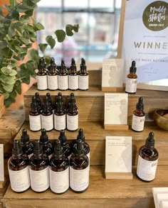 several bottles of wine sit on a table with cards and labels in front of them