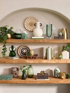 the shelves are filled with vases, plants and other decorative items on top of them