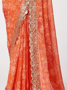 Be an angel and create and establish a smashing influence on every person by wearing this orange organza wedding wear saree. The designer, floral printed with sequin embroidery work and zari work appears to be chic and best for any occasion. This beautiful orange organza saree comes with a similar color blouse embellished with the same design as the saree. This cute orange wedding wear saree is 5.75 meters long and comes with fully unstitched 0.80 meters blouse material. Update your clothing sty Anarkali Pre-draped Saree With Printed Border For Festivals, Festive Orange Pre-draped Saree, Pre-draped Saree With Printed Border For Festive Occasions, Orange Pre-draped Saree With Pallu For Wedding, Chanderi Pre-draped Saree With Printed Motifs For Wedding, Orange Pre-draped Saree With Dupatta For Festivals, Orange Pre-draped Saree For Wedding And Diwali, Orange Organza Festival Set, Orange Organza Set For Festivals