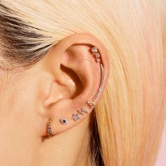 a woman with blonde hair and ear piercings