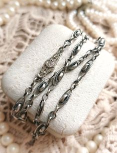 "Beautiful Antique French Late XIX-Century to 1910s Silver (Marked) Ornate Chain Necklace with Diamond Paste Closure, Gift for Woman  Size -  Total length - approx. 43cm / 16,92\" Chain is in a perfect antique condition, very high quality, thick and heavy, beautifully detailed with ornate segments, made of a silver and diamond paste stones in an elegant clasp. So sophisticated, unique piece! ✨  Perfect as a gift for antique and vintage loving woman! 🧡 Great also as a vintage wedding jewelry!  Found somewhere in France :)  __ Maybe you are looking for something specific from France? 🕵️♀️😗 If you like, you can contact me and ask! With a pleasure I will look for it and check if I can find it for you! ❤️" Luxury Antique Jewelry With Sterling Silver Clasp, Luxury Antique Silver Jewelry As Gift, Luxury Antique Jewelry With Box Chain, Luxury Handmade Antique Silver Necklace, Luxury Sterling Silver Jewelry With French Hook, Luxury Antique Jewelry With Adjustable Chain, Elegant Vintage Charm Oval Link Jewelry, Elegant Jewelry With Vintage Charm And Oval Link, Antique White Gold Necklace