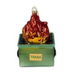 a glass ornament in the shape of a fire hydrant on top of a trash can