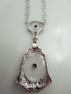 "For Sale: (1) g610 Elegant Ladies 14kt White Gold Diamond Filigree Necklace Pendant PLEASE READ ENTIRE DESCRIPTION BEFORE PURCHASING This is a stunning piece. Set in 14kt white gold, this camphor piece comes attached to the long and short style chain. Centered in the bigger part of the pendant, is a .02ct old mine cut diamond. Perfect for that special occasion. Would be a nice birthday, anniversary, Mother's Day or Valentine's Day gift for her! Specifics: 14kt White Gold Camphor Glass Diamond w Evening Platinum Necklace With Diamond Cut, Evening Platinum Diamond Cut Necklace, Platinum Diamond Cut Necklace For Evening, Diamond Cut Pendant Necklace For Evening, Evening Pendant Necklace With Diamond Cut, Diamond Cut Pendant Necklaces For Evening, Art Deco Platinum Jewelry For Evening, Exquisite Hallmarked Diamond Necklace For Formal Occasions, Platinum Pendant Necklace For Evening