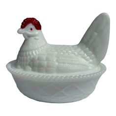 a white ceramic chicken sitting in a bowl