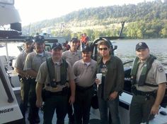 a group of men standing next to each other on a boat