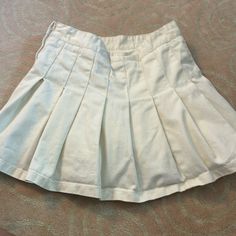 In Excellent Condition, Never Worn. Has Under Shorts In The Skirt. From Brandy Melville Short Cotton Pleated Skirt, Pleated Cotton Skirted Bottoms, Short Pleated Cotton Skirt, Cotton Pleated Short Skirt, White High Waist Pleated Shorts, Pleated Short Mini Skirt For Day Out, Pleated Cotton Short Skort, Spring Pleated Cotton Tennis Skirt, Pleated Cotton Skirted Skort