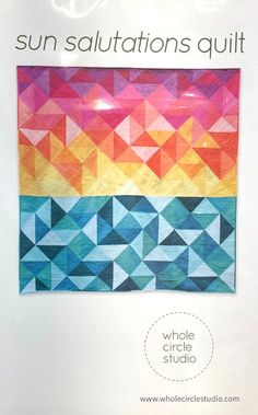 the back cover of a quilt book with an image of a colorful sunset on it