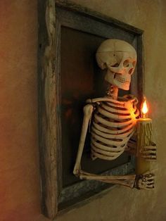 a skeleton holding a lit candle in it's hand and looking out the window