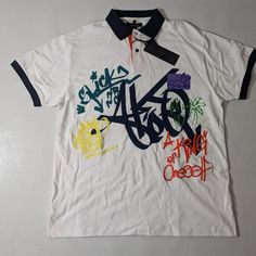 New With Tags Men's Akoo Men’s Short Sleeve Polo Shirt Street Art 100% Cotton Color: White W/ Street Art Designs Size Small Msrp $75 Casual White Polo Shirt With Graphic Print, Summer Cotton Polo Shirt With Graphic Print, Graphic Print Polo Shirt For Summer Streetwear, Summer Graphic Print Polo Shirt For Streetwear, Collared Polo Shirt With Graphic Print For Streetwear, Casual Graphic Print Polo Shirt For Streetwear, Collared Graphic Print T-shirt For Streetwear, White Polo Shirt For Summer Streetwear, Graphic Print Collared Polo Shirt For Streetwear