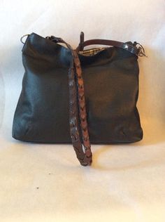 "One in stock This Leather Handbag Equestrian Horse Purse with a Horse bit was first introduced to my collection in 2019 . It combines quality leather and a total equestrian look making this your go to bag. The leather is soft and supple yet sturdy enough to be tossed in the car or your tack trunk. Pictured is an equestrian print with side saddle ladies. You can choose another fabric to truly make it your own. Prices of lining fabric will vary depending on your choice. It has one zip pocket and Formal Leather Bucket Bag With Leather Trim, Luxury Saddle Shoulder Bag With Palladium Hardware, Brown Crossbody Bag With Palladium Hardware, Designer Hobo Bag With Leather Handles For Daily Use, Luxury Black Bucket Bag With Leather Trim, Luxury Leather Bucket Bag With Leather Trim, Luxury Leather Hobo Bag For On-the-go, Leather Saddle Shoulder Bag With Palladium Hardware, Everyday Saddle Bags With Leather Handles