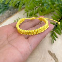 "Happy color macrame bracelet made of waxed cord. This waterproof adjustable bracelet has the perfect color to transmit energy, vibrant yellow! The color of the sun. This happy bracelet was designed for everyday wear. This minimalist boho yellow cord bracelet enhances your casual outfit.  ♥ ITEM DETAILS: Total length: The size of the bracelet is adjustable.  💕The bracelet has an adjustable closure that will work on a wrist of about 6 - 7\"💕 Materials: Waxed cord Waxed Cord Available: Yellow Waxed Cord Size: 1mm waxed cord ♥ GIFT IT Jewelry comes in a cute canvas bag ready to gift! If you wish your item to be a gift, please let me know and I will include a cute little card with a personal message. ♥ CURRENT PROCESSING TIMES: normally we ship orders out within 1-3 days  (the time I need to Yellow Bohemian Friendship Bracelets For Everyday, Yellow Bohemian Friendship Bracelets, Bohemian Yellow Friendship Bracelets, Yellow Resizable Jewelry For Friendship, Handmade Trendy Yellow Friendship Bracelets, Casual Yellow Friendship Bracelets, Trendy Adjustable Yellow Friendship Bracelets, Trendy Yellow Adjustable Friendship Bracelets, Handmade Yellow Friendship Bracelets