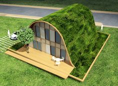 an unusual house with grass on the roof