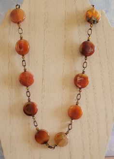 I fell in love the with rainbow hues in these coin shaped Carnelian beads.  In the sun, the colors just glow!  I've paired them with copper chain links and a copper toggle clasp.  I've also paired these beads with matching 2x ab Carnelian bicone crystals.  This necklace measures approximately 20 inches. Orange Gemstone Beads Round Jewelry, Orange Round Gemstone Bead Jewelry, Orange Agate Oval Beads Jewelry, Orange Round Gemstone Beads Jewelry, Orange Agate Oval Beaded Jewelry, Polished Round Carnelian Beads Jewelry, Handmade Amber Agate Beads, Gems, And Cabochons, Handmade Orange Beads For Jewelry Making, Bohemian Carnelian Beaded Necklaces