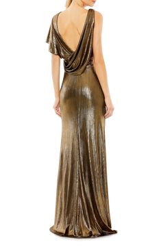 a woman wearing a gold dress with an open back and draped over the shoulder,