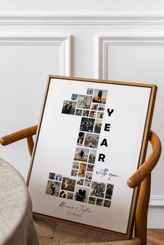 a wooden chair sitting in front of a white poster