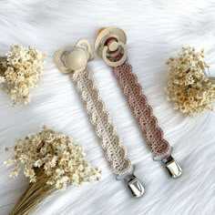 three crocheted items are laid out on a white furnishing with dried flowers in the background