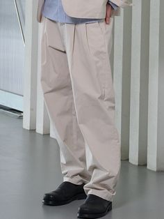 This is a minimal and comfortable pants made out of high quality cotton, polyester, and rayon blend fabric. With minimal design detail of adjustable belt on the waistband, tuck detail for wide silhouette, and back welt pockets, it gives a modern and refined mood to your look.- Welt pockets on the back- Adjustable belt on the waistband- Double tuck on the front- Set up with matching jacket Relaxed Fit Solid Color Chinos With Belt Loops, Modern Cotton Cargo Pants For Spring, Modern Cotton Pants With Elastic Waistband, Relaxed Fit Cotton Belted Bottoms, Belted Relaxed Fit Cotton Bottoms, Belted Cotton Bottoms With Relaxed Fit, Relaxed Fit Chinos With Belt Loops, Casual Relaxed Fit Belted Pants, Casual Relaxed Fit Belted Bottoms