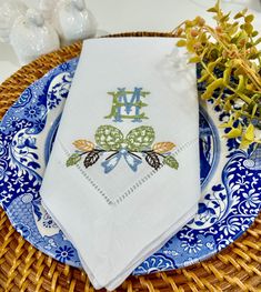 a blue and white plate topped with two napkins