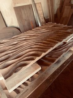 a wooden bench made out of plywood and other pieces of wood sitting on top of each other