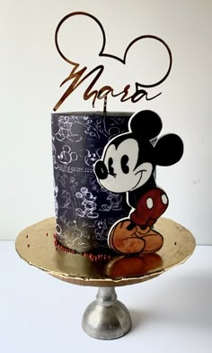 a mickey mouse cake on a gold plate