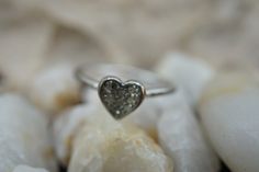 This is the perfect option for those who like cool, unique jewelry and the luxury, shine of silver. This ring is well made, cute and/or elegant in design, and very desirable. The size of the ring is 5. This ring is decorated with a heart and cz. The heart is about 1/4'' x 1/4''. ♥ Age/era: Circa 1970s - 1980s. ♥ There is a hallmark: SL.925. ♥The ring has one cz lost. Every one interested in the jewelry should remember that he or she must like their jewelry- not just at first sight.... but for al Dainty Sparkling Wedding Rings, Sparkling Dainty Wedding Rings, Minimalist Silver Heart Ring For Promise, Fine Jewelry Sparkling Stackable Rings As Gift, Fine Jewelry Stackable Sparkling Rings, Gift Silver Sparkling Stackable Rings, Minimalist Silver Diamond Ring Gift, Elegant Silver Stackable Heart Cut Rings, Elegant Silver Heart Cut Stackable Rings