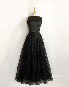 "This stunning full length bridal overskirt is made from our beautiful 3D Peggy Lace. It is a generous full-circle skirt with an extra layer of tulle underneath for extra volume and a high fitted waistband in satin crepe. It is seen here in a dramatic black but can also be made in ivory. Photographed in black with the Elvira Wedding Gown in Black Satin Crepe: https://www.etsy.com/uk/listing/1403872161/elvira-wedding-gown-in-black-satin-crepe?click_key=75e96a7c5c1443f514a630a1b8cd8b2087eaa4a8%3A1 Black Full Skirt Wedding Dress, Long Organza Skirt For Evening, Evening Gown With Full Skirt, Formal Tulle Dress With Flowy Skirt, Black Full-length Evening Dress For Wedding, Party Floor-length Organza Skirt, Elegant Floor-length Ball Gown With Tulle Skirt, Black Tulle Maxi Skirt For Evening, Elegant Floor-length Maxi Skirt For Wedding