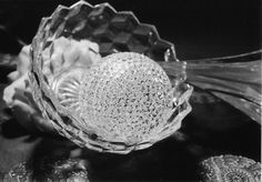 a glass bowl filled with lots of glitter next to some other items on a table