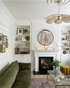 a living room filled with furniture and a fire place in front of a white fireplace