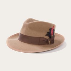 An icon of the Stetson brand, the Whippet Fedora epitomizes the sophisticated style of the American post-war era with its timeless, versatile profile and a brim that can look casual and cool when snapped up, or snapped down for a dressed-up and dapper look. Handcrafted with a firm finish from high-quality 100% wool felt and richly dyed in versatile shades, the Whippet features a slightly tapered 4 ½" pinch front teardrop crown and a 2 ⅜” bound edge brim. Its classic style is underscored by a gro Wool Fedora Hat, Stetson Hat, Wool Fedora, Casual Bottoms, Denim Boots, Wide Trousers, Thigh Boot, Women Shirts Blouse, Whippet