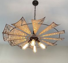 a chandelier hanging from the ceiling in a room with light bulbs on it