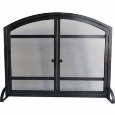 a black fireplace screen with two doors