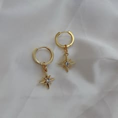 🖊️ Product details 🖊️ Handmade 18K Gold Plated Brass huggie earrings. Suitable for sensitive ears. Star charm: 12mm Huggie: 1.4cm in diameter Earring pin: 1mm 🫶 Product care 🫶 - To avoid your jewellery tarnishing from moisture and liquids, please refrain from wearing then in places such as pools and during intense exercise. - Keep your jewellery protected from the sun and safe from scratches and chips. It's best if you store your jewellery in air tight space. - Our jewellery are handmade with love, so please handle them carefully 😊 💌 Handling 💌 Please allow for 1-2 business days for your pieces to be made and packaged with care. Your order will be shipped in a padded envelope to ensure that your jewellery arrives safely. 💛 Thank you for choosing our store, we hope you love your goo Y2k Earrings, Earring Pins, Cute Ear Piercings, Sleeper Earrings, Coin Earrings, Dangly Earrings, Huggie Earrings, Star Charms, Sensitive Ears