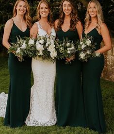 bridesmaids in green dresses holding bouquets and smiling for the camera at their wedding