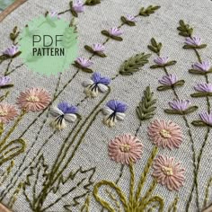 a close up of a embroidery pattern with flowers on it