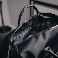 Designed to be minimal and understated, we've made a bag perfect for everyday use. Our minimalist holdall has an outer zip pocket, a grab handle, three inside pockets, and a leather shoulder strap, as well as a magnetic slot for easy access to your belongings. 47cm x 22cm x 27cm (can be used as carry-on luggage). Water-resistant. 28-litre capacity. Includes detachable shoulder strap. Outer zip pocket perfect for accessories. Two open inside pockets and one inside zipped pocket. Made from vegan l Minimalist Bags With Zipper Closure, Classic Everyday Duffle Bag With Double Handle, Modern Satchel With Zipper Pocket For Daily Use, Minimalist Business Shoulder Bag With Leather Handles, Modern Daily Use Satchel With Zipper Pocket, Classic Laptop Bag With Zipper For Commuting, Minimalist Satchel Bag With Zipper Closure, Modern Everyday Travel Bag With Zipper Pocket, Modern Duffle Bag For Everyday Use With Double Handles